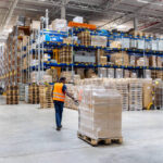 A customs officer inspecting a shipment, highlighting the importance of proper customs clearance for electronics.