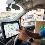 A delivery driver operating IoT last-mile delivery tracking dashboard